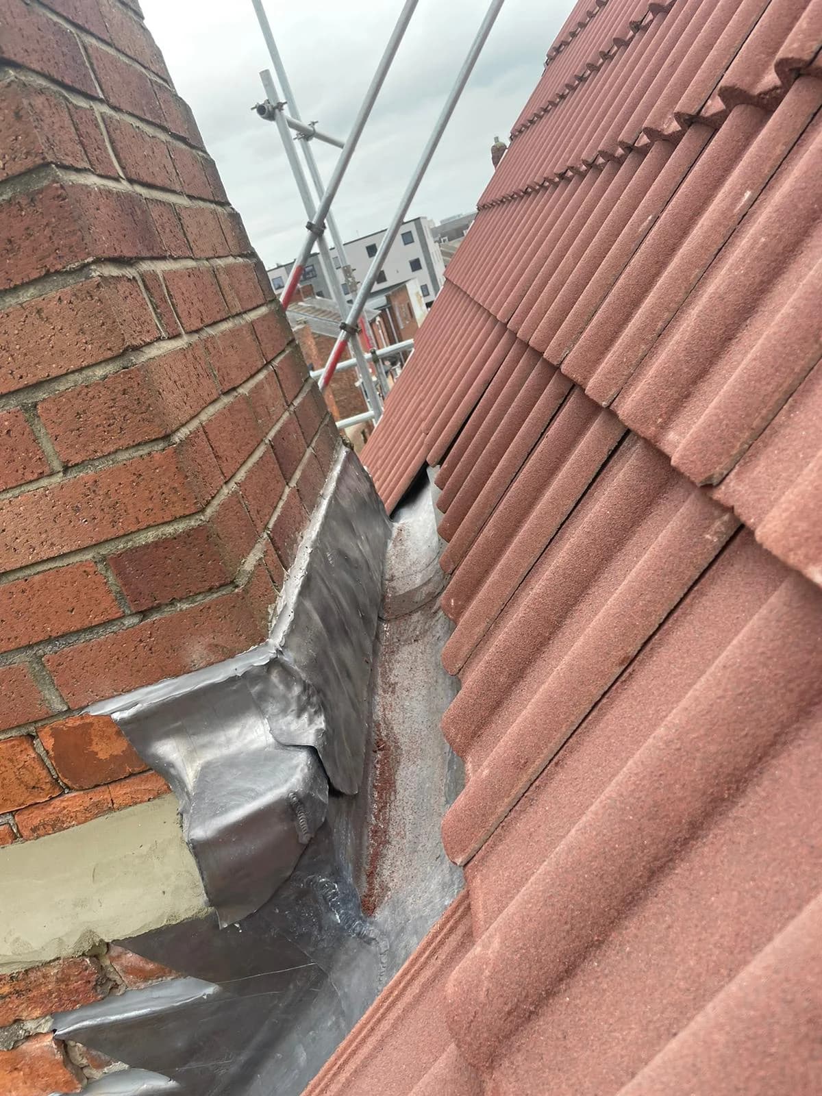 A completed slate roof catching low sunlight